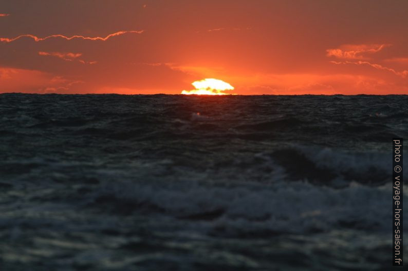 Le disque du soleil plonge dans la mer. Photo © André M. Winter