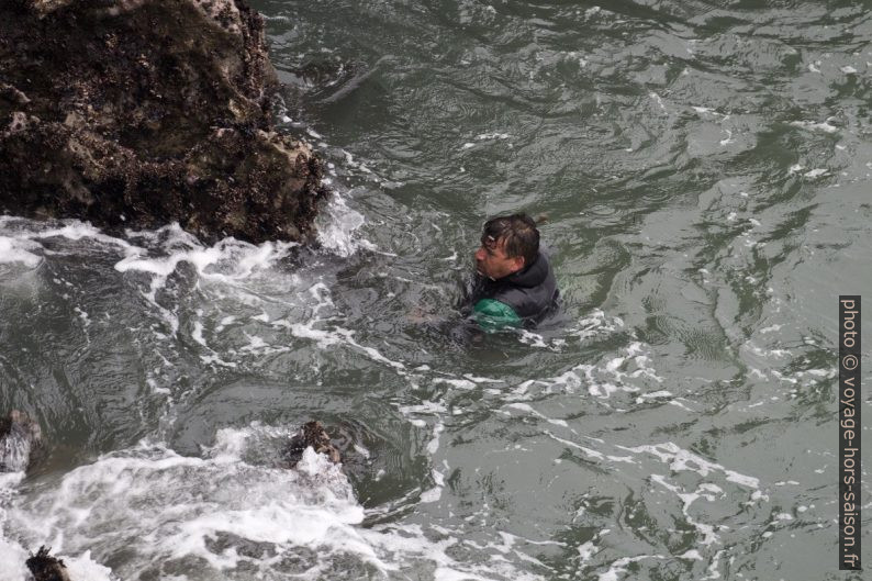 Un pêcheur de pédonculés en combinaison entre les rochers. Photo © André M. Winter