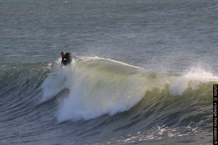 Un surfeur s'élance sur une vague. Photo © André M. Winter