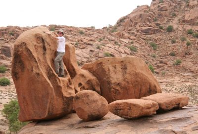 André sur un rocher granitique erodé. Photo © Alex Medwedeff